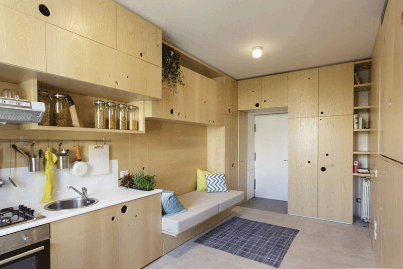 Small apartment in Milan opening cabinet doors