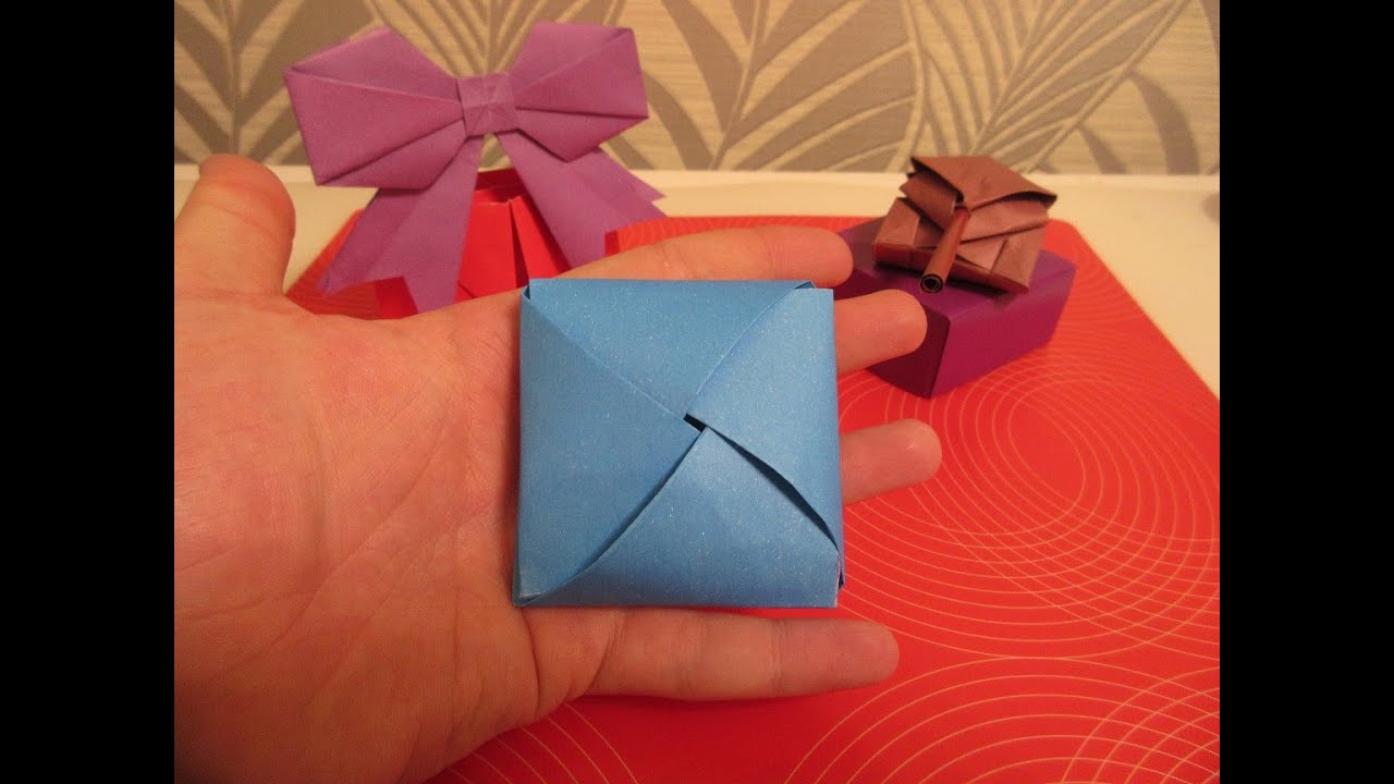 Сделать подарок оригами. Подарочный конверт оригами. Оригами коробочка для подарка. Оригами подарок на день рождения. Конверт сюрприз из бумаги.
