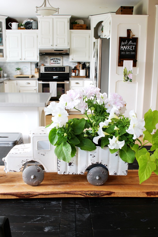 Vintage truck flower planter used as a centerpiece on a kitchen table.